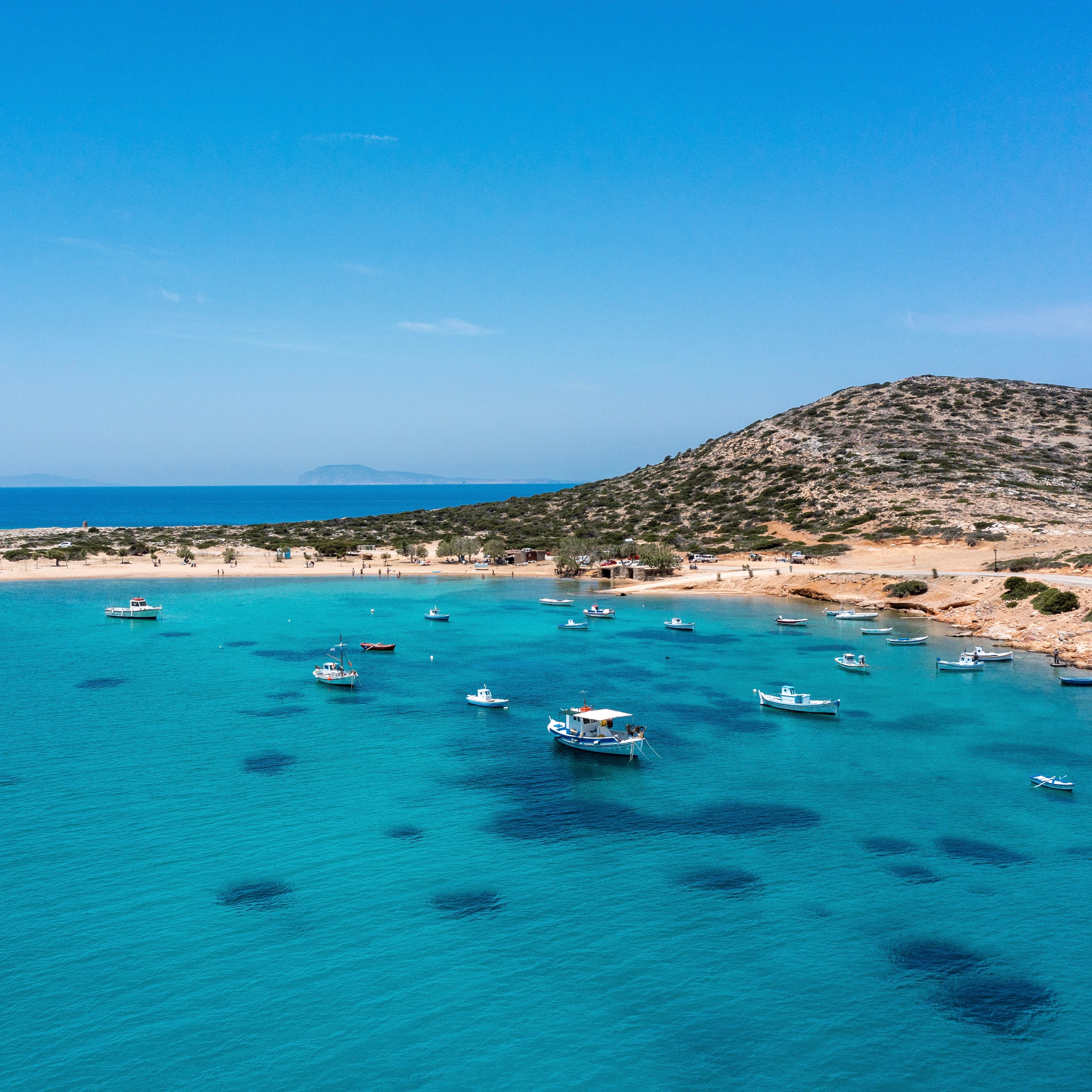 Fishing boats in a turquoise cove on Amorgos