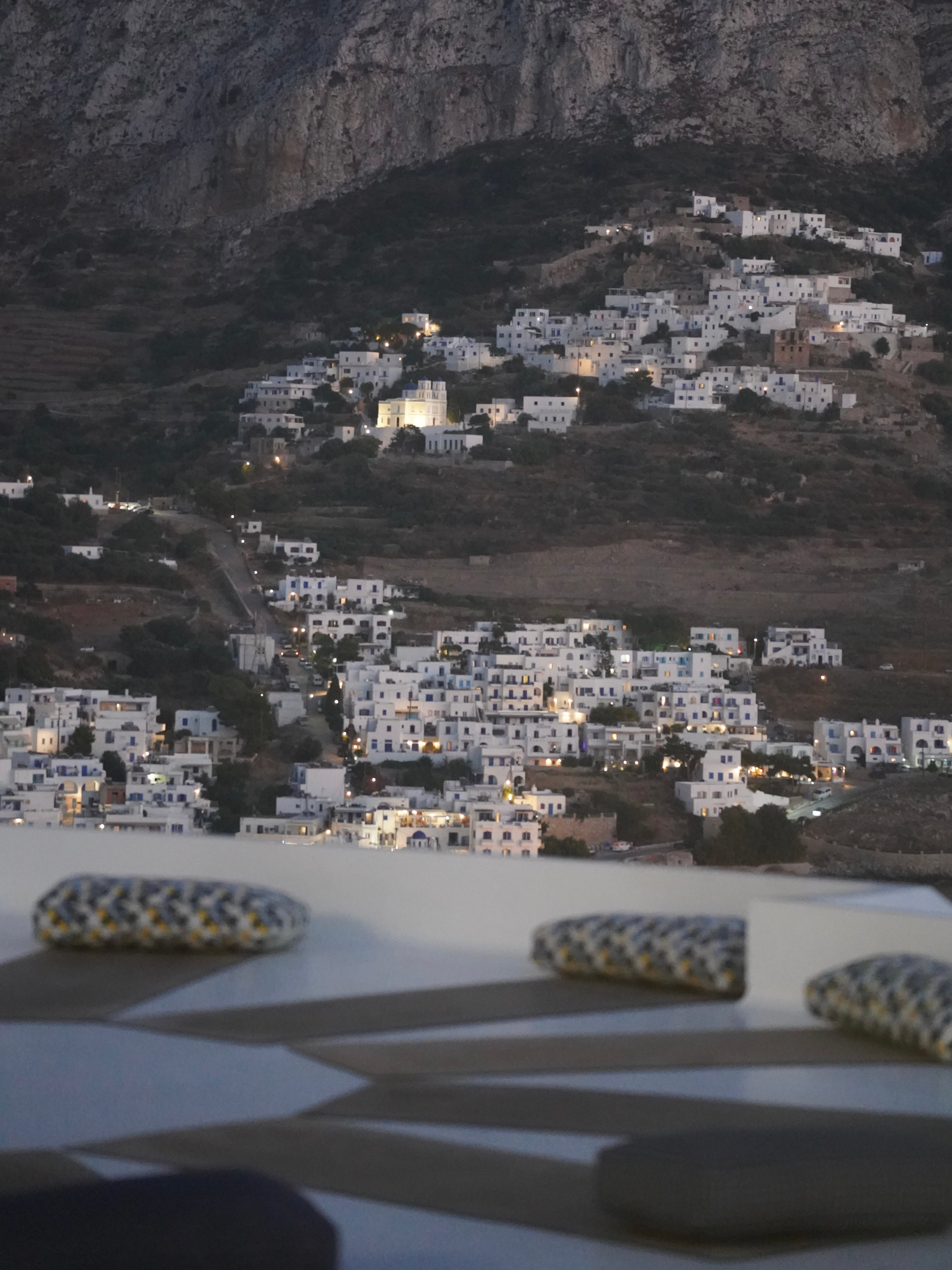 The lit village across the bay at night
