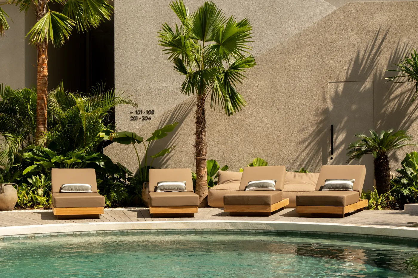 Loungers and palms along the pool terrace at the hotel in Uluwatu