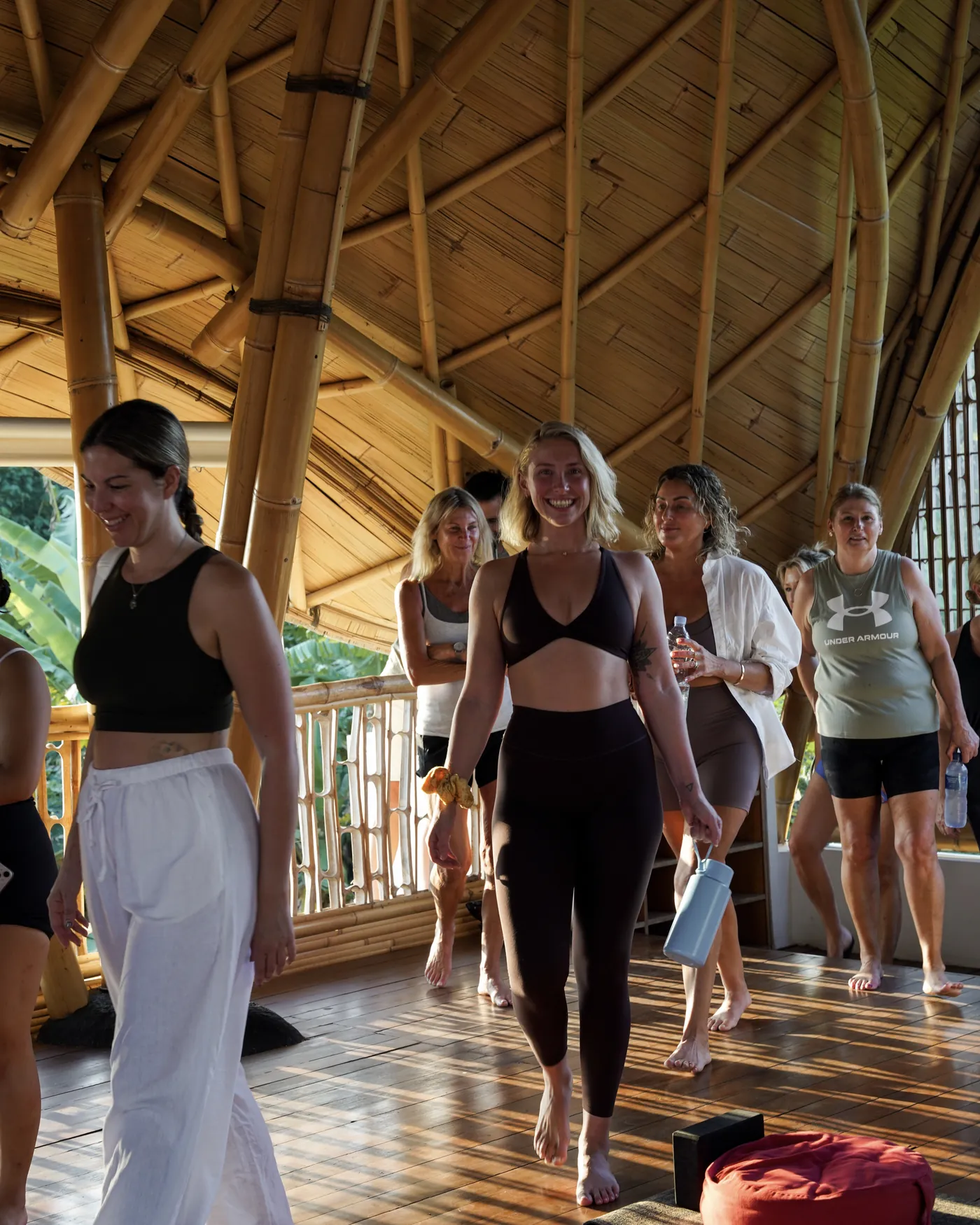 The group walking through the bamboo shala, laughing